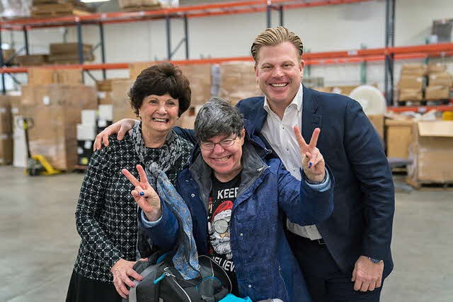 Edwards Center founder Jean Edwards and Fournier Group CEO a Resident at a volunteering event